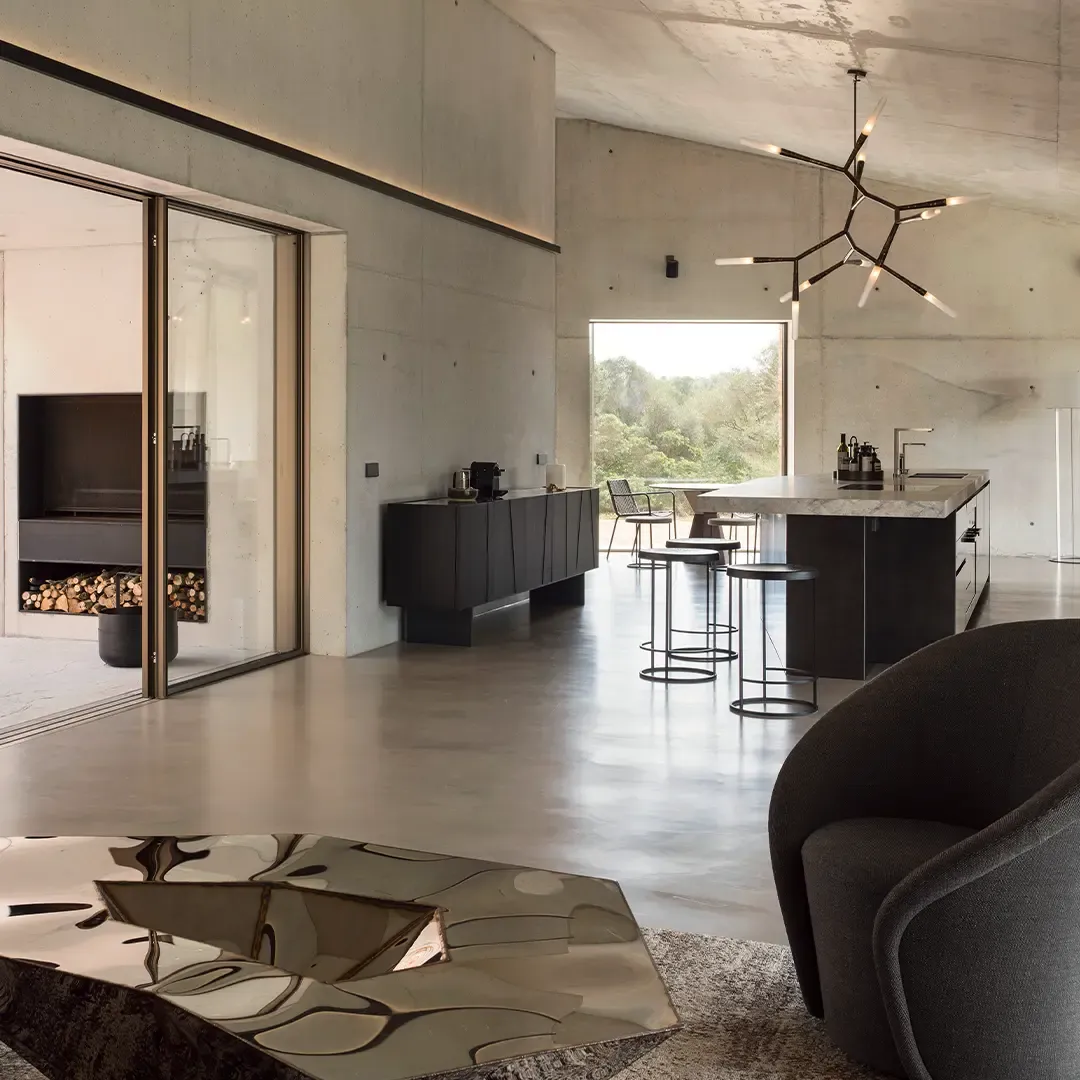 Salón comedor de doble altura con pavimento continuo de microcemento